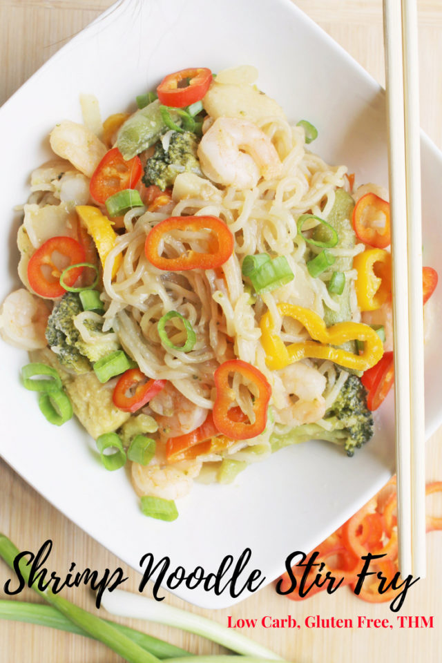 Shrimp Noodle Stir Fry in a white bowl with some chopsticks laying on the side of the bowl. This is a pin for saving on Pinterest. 