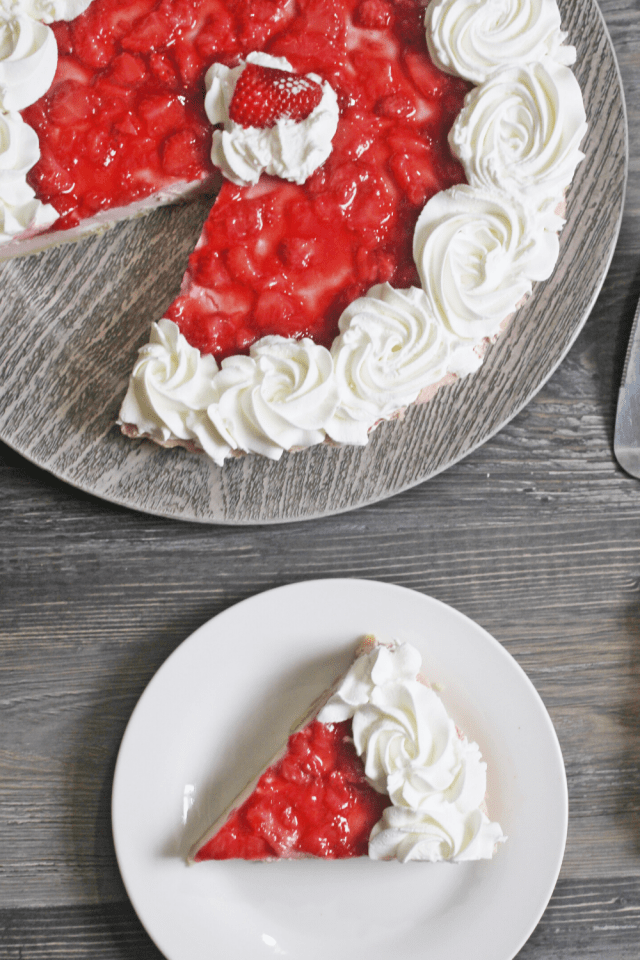 A low carb creamy cheesecake topped with a simple fresh strawberry topping. #lowcarbcheesecake #thmdesserts #sugarfree