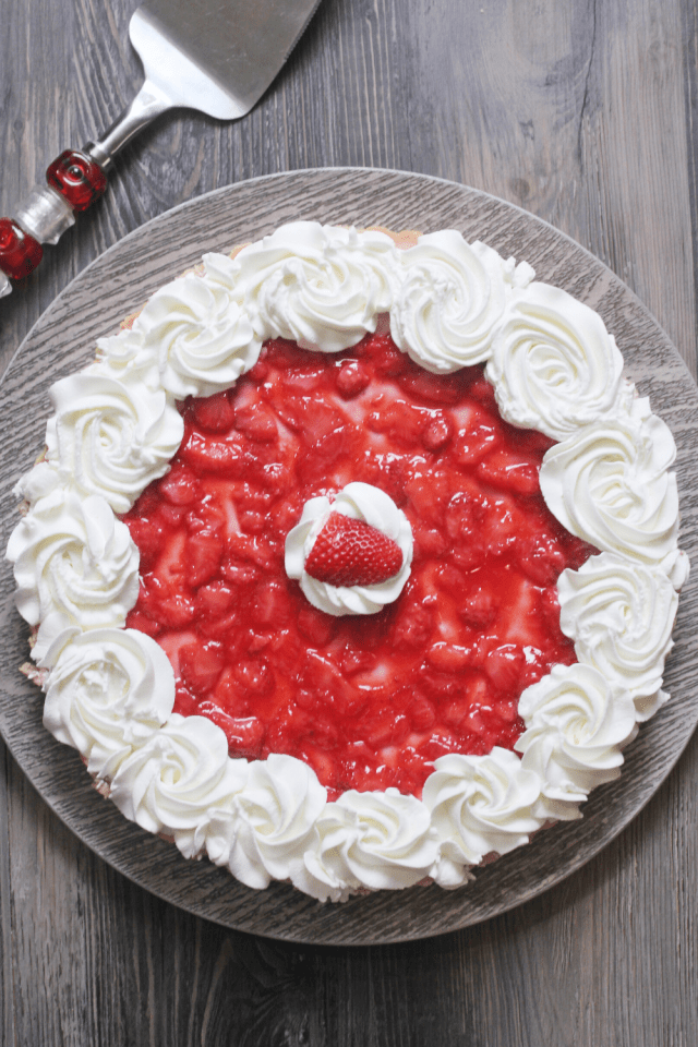 A creamy sugar free and low carb cheesecake topped with fresh strawberries and homemade whip cream.