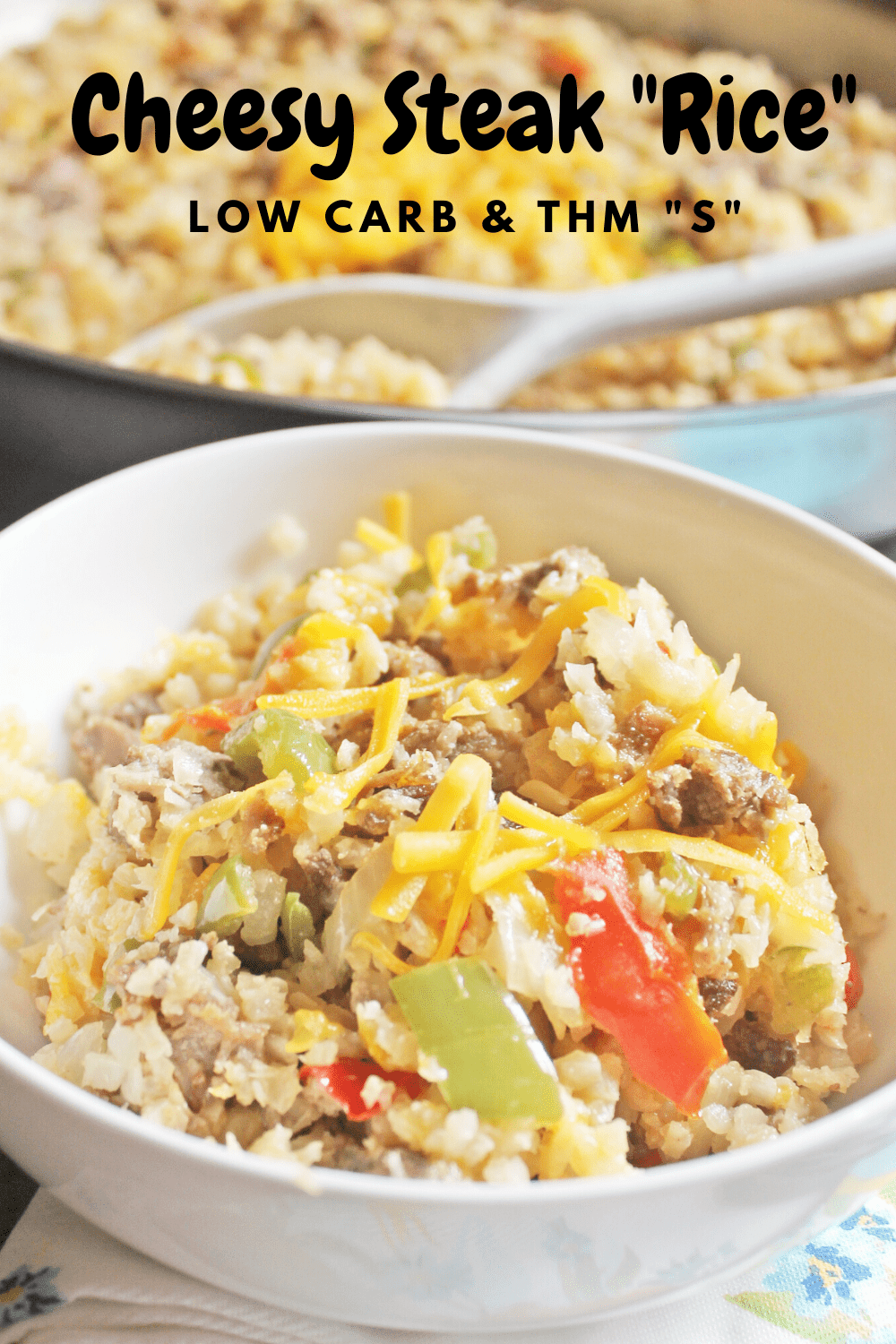 Cheesy Steak "Rice" is a low carb and THM skillet meal that features cauliflower rice loaded with steak, onions and peppers and cheese. 