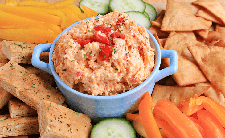 Yummy Bowl of Pimento Cheese Spread with items to dip into it.