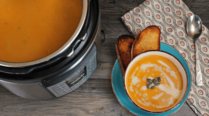 An Instant Pot full of Butternut squash soup and a bowl.