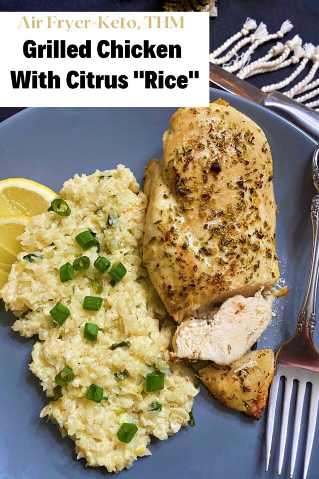 Grilled Chicken breast that has been sliced at one end laying on a gray plate next to cauliflower rice. 