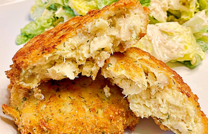 Two fish cakes, one whole and one that is broken open to show the center of the fish cake.